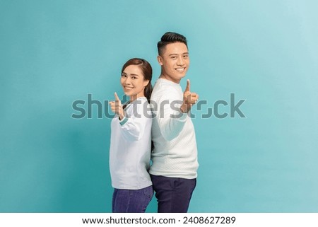 Group of two people on yellow background points finger at you with a confident expression