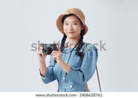 Pretty woman taking a photo using classic slr camera