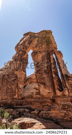 Portrait shot of big Druid arch against blue sky in canyonlands national park in Utah, america, usa Royalty-Free Stock Photo #2408629231
