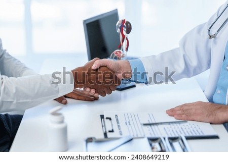close-up handshake between two individuals, doctor and other casual shirt. doctor-patient relationship, agreement on treatment plan,  conclusion of medical consultation. Royalty-Free Stock Photo #2408649219