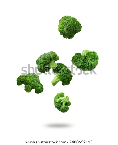 Fresh green broccoli falling on white background Royalty-Free Stock Photo #2408652115