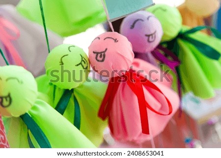 Cute and colorful japanese doll called Teru Teru Bozu is believed to prevent rain and keep the weather clear when we hang it near window. Royalty-Free Stock Photo #2408653041