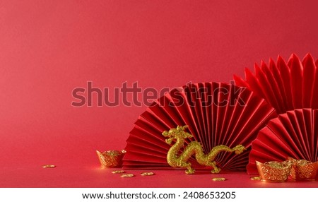 Festive Lunar New Year setting: side view table adorned with feng shui essentials, gold coins, dragon figurine, and fans on a vibrant red backdrop. Empty space for text