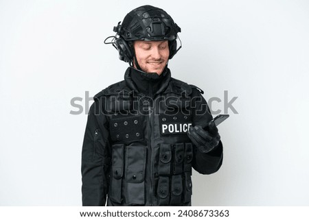 SWAT man over isolated white background keeping a conversation with the mobile phone with someone