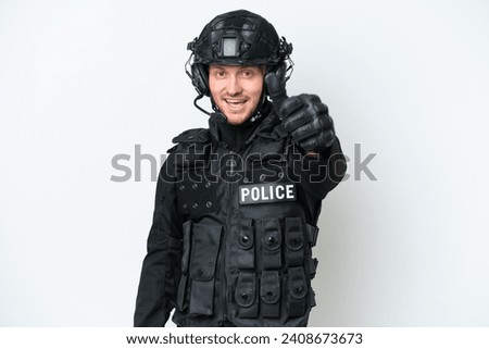SWAT man over isolated white background with thumbs up because something good has happened