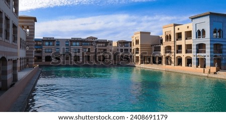 EGYPT, MARSA ALAM - APRIL 20, 2010: Arabic style hotel facade with water canal in the courtyard from the Red Sea, Port Ghalib, Marsa Alam