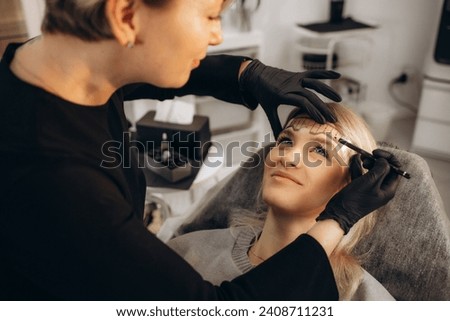 Cosmetician making measuring with ruler and getting ready to apply makeup to a client. Closeup shot. High quality photo