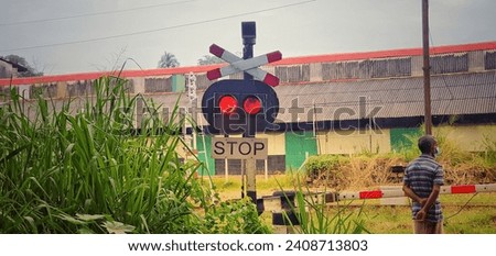 Railway crossing with red lights and stop sign