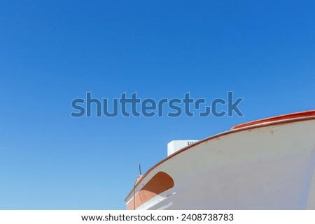 Close up of a fishing boat against a blue sky with copy space