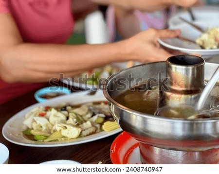 a photography of a table with plates of food and a bowl of soup.