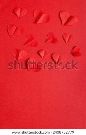 Valentines day card mockup with red paper hearts on red paper background, top view, copy space. vertical photo