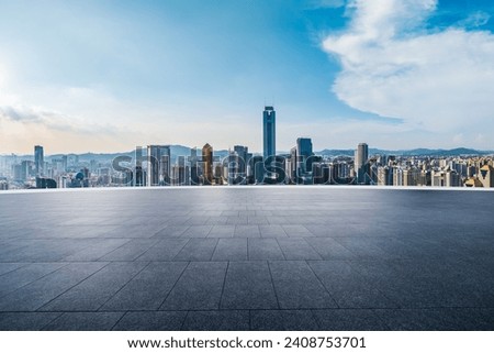 Empty square floor and modern city buildings under blue sky. high angle view.