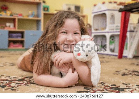 happy girl playing in kindergarten in group with toys, constructor. High quality photo