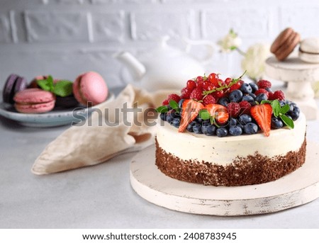 festive chocolate cake with vanilla cream and berries