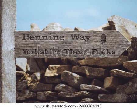 Pennine Way - Yorkshire Three Peaks fingerpost sign on Pen-y-ghent Royalty-Free Stock Photo #2408784315