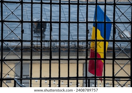 Romanian flag seen through the  bars, landscape image