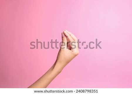 Hand doing Italian gesture with fingers together isolated over pink background Royalty-Free Stock Photo #2408798351