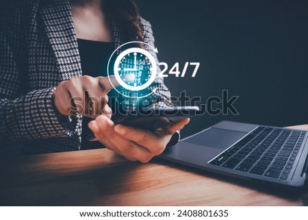 Businesswoman holding smartphone showing virtual 24-7 with clock. Worldwide nonstop and full-time available contact of service. Nonstop service, Care and consulting client 24hr customer service. Royalty-Free Stock Photo #2408801635
