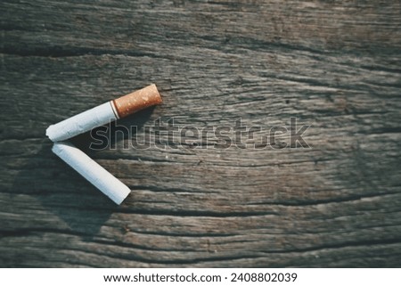 close up cigarette on wood table, copy space for text, medical and healthcare, stop smoking, 31 may world no tobacco day concept Royalty-Free Stock Photo #2408802039