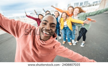 Multiracial young people smiling at camera outside - Happy group of friends with arms up celebrating together - University students having fun in college campus - Youth community concept