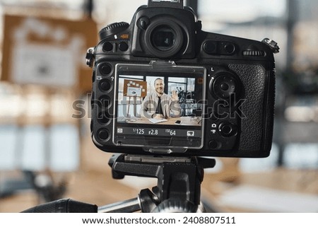 close up view of digital camera near cheerful businessman recording video content in modern office