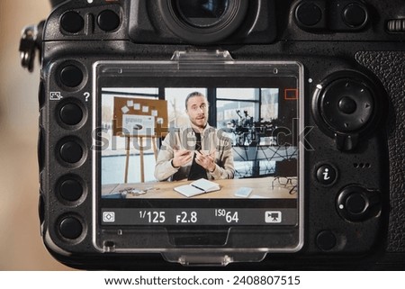 close up view of digital camera near successful entrepreneur recording video blog in modern office