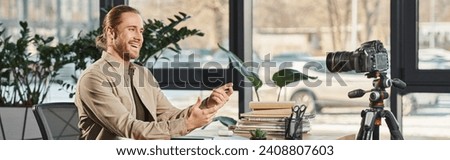 cheerful entrepreneur talking and gesturing in front of digital camera at workplace, banner