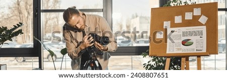 manager in casual attire adjusting digital camera near flip chart with graphs in office, banner