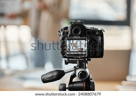 selective focus on digital camera near blurred entrepreneur recording video blog in modern office