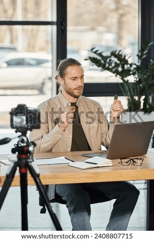 confident businessman holding bitcoins during video call on laptop in front of digital camera