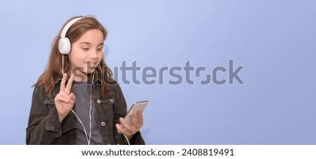 Horizontal banner of a girl greets a friend with a white mobile phone and white headphones in the messenger. purple background