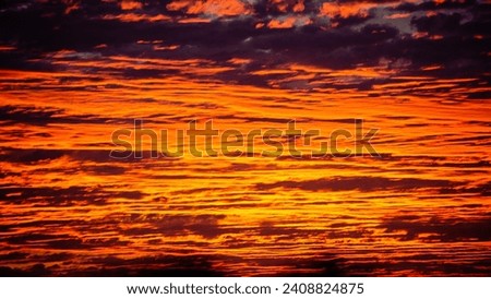 Cloudscape shot of the sunset red cloudy skyline background. 