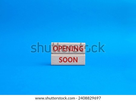 Opening soon symbol. Concept word Opening soon on wooden blocks. Beautiful blue background. Business and Opening soon concept. Copy space