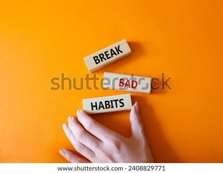 Break bad habits symbol. Concept words Break bad habits on wooden blocks. Beautiful orange background. Doctor hand. Medicine and Break bad habits concept. Copy space.