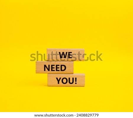 We need you symbol. Concept words We need you on wooden blocks. Beautiful yellow background. Business and We need you concept. Copy space.