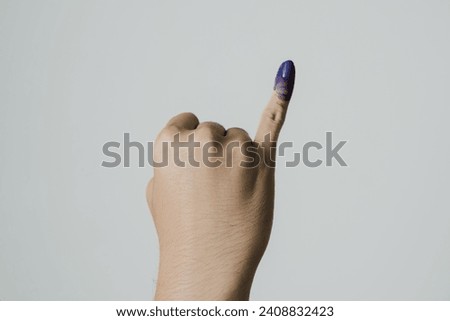 Purple ink applied on little finger after pemilu or Indonesian presidential election