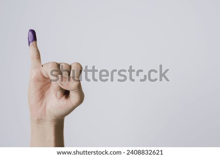 Purple ink applied on little finger after pemilu or Indonesian presidential election