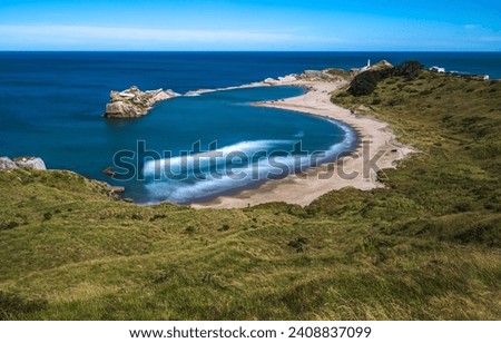 Beautiful beach landscape on the seashore. Sandy beach of sea bay. Blue lagoon on sandy beach. Sand beach landscape Royalty-Free Stock Photo #2408837099