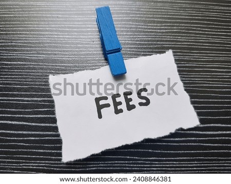 Fees written on a black background.
