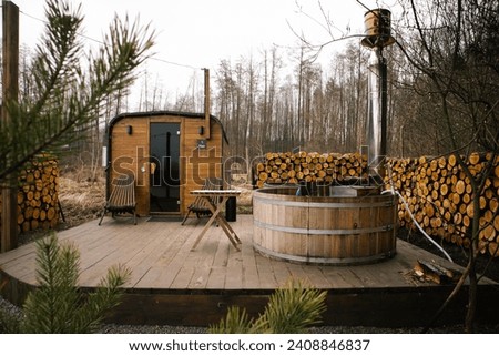 Wooden outdoor sauna with hot pot for perfect relaxation among the trees 