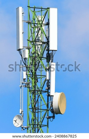 antenna  on green communication tower on blue sky background