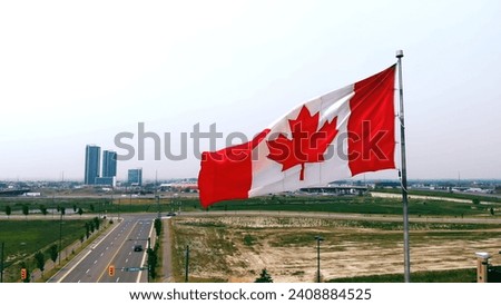 Flag of Canada on sky background in close-up fluttering in wind symbol of national borders freedom Canada flag on flagpole exemplifies patriotism uniqueness. Canada flag represents national identity.