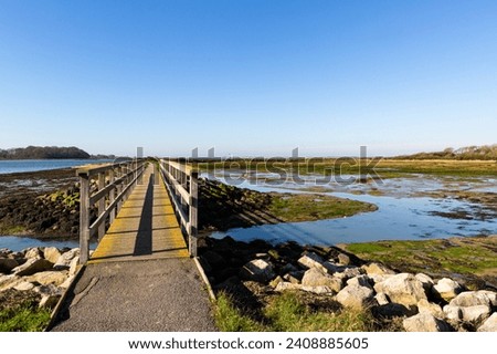 Wooden structures along the coast. The picture was taken at low tide along the mud banks of Chichester harbour in West Sussex.