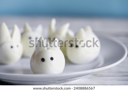 Fun food for kids. Hard boiled baby bunny eggs perfect for Easter parties. Alternative to candy. Shallow depth of field with selective focus on egg at edge of plate.