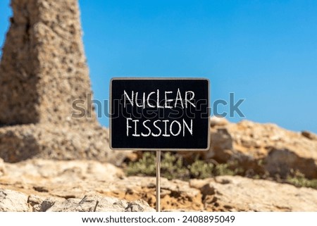 Nuclear fission symbol. Concept words Nuclear fission on beautiful black chalk blackboard. Chalkboard. Beautiful stone blue sky background. Business science nuclear fission concept. Copy space. Royalty-Free Stock Photo #2408895049