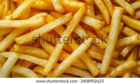 Crispy French Fries Close-Up - A mesmerizing close-up of crispy, golden French fries, highlighting each fry's perfect texture and irresistible appeal. Royalty-Free Stock Photo #2408902625