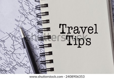Travel tips word text written on notepad and maps as background with pen 