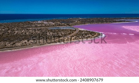 view from drone, overlooking Hutt Lagoon, Pink Lake in Western Australia, small bridge and road visible with the Indian Ocean in the background. Royalty-Free Stock Photo #2408907679