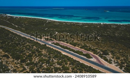 Coastal highway and sandy beach with clear blue water. Indian Ocean Drive - Western Australia Royalty-Free Stock Photo #2408910589