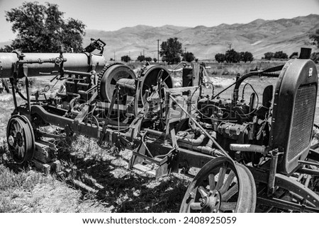Antique purpose built farm equipment with a winch and air compressor. Black and white. Royalty-Free Stock Photo #2408925059
